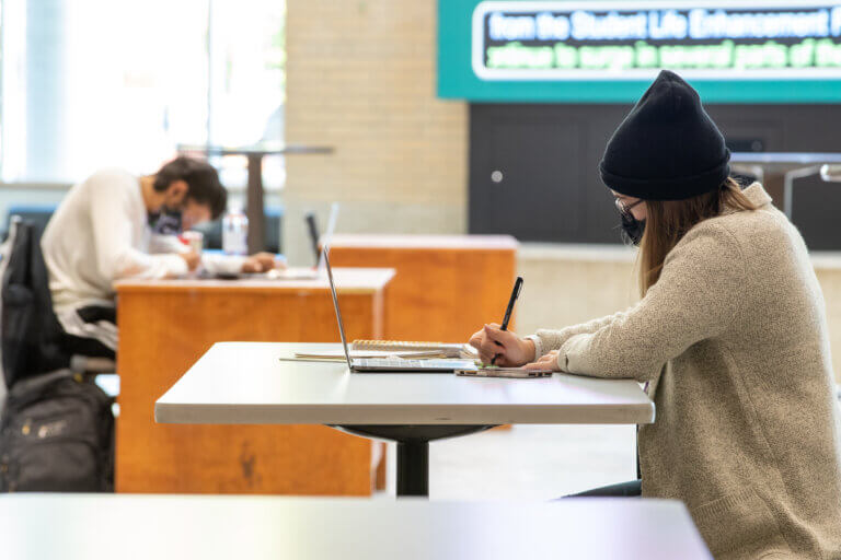 Students studying in MUSC wearing McMaster branded face masks.