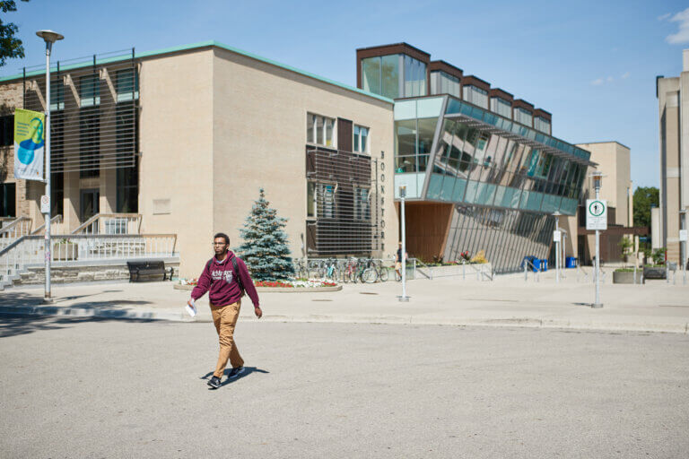 Student walking past Student Centre.