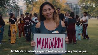 Student holding welcome sign.