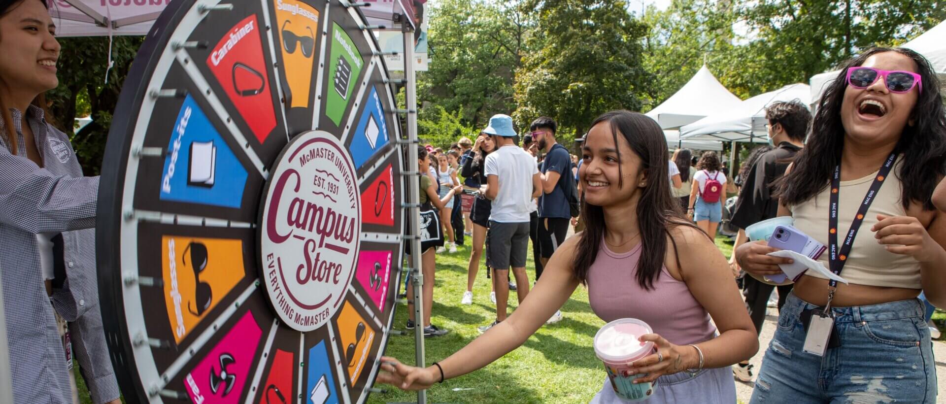 Students spinning wheel at carnival Welcome Week event.