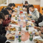 students enjoying food around a table