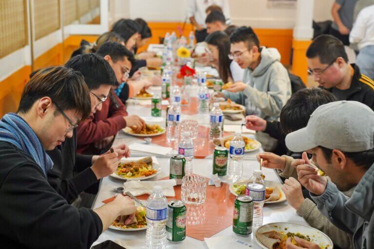 students enjoying food around a table