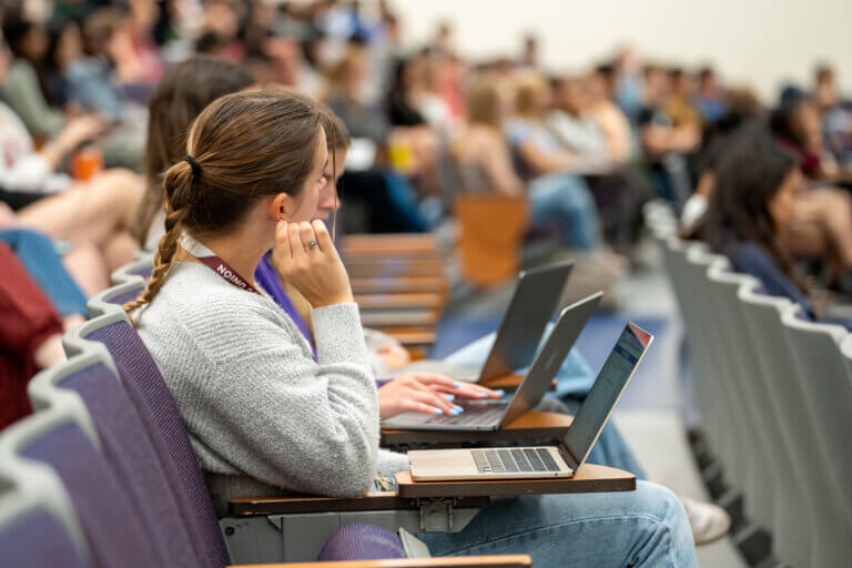 Students in a lecture on their laptop