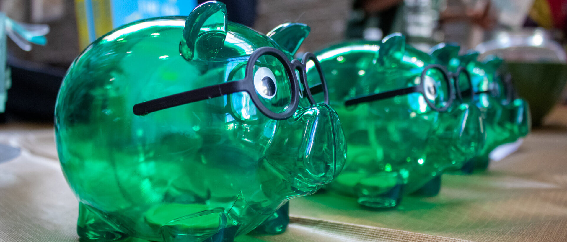 Green piggy banks with glasses