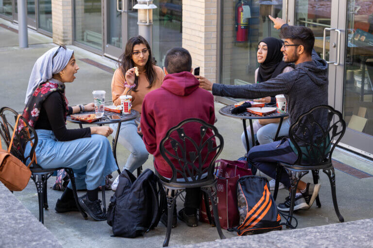 Students around a table talking
